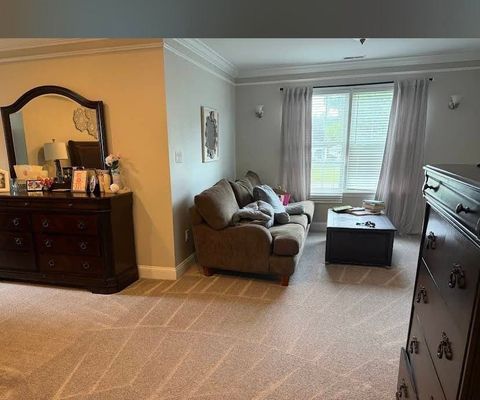 A large bedroom with freshly steam-cleaned beige carpet