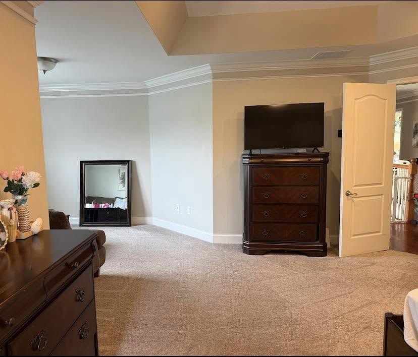 A freshly cleaned bedroom carpet showing even cleaning lines